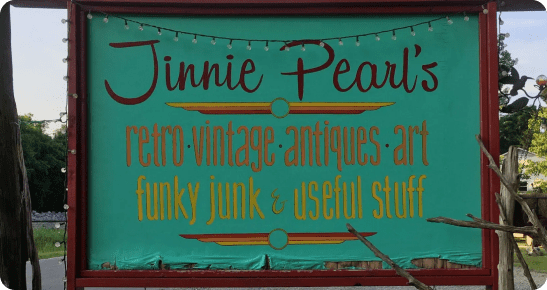 A sign for jinnie pearl 's retro-vintage antiques and junk.