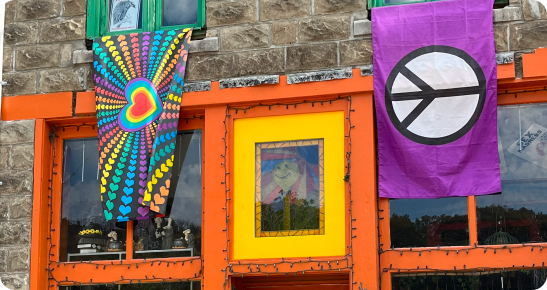 A colorful building with several different flags hanging from it.