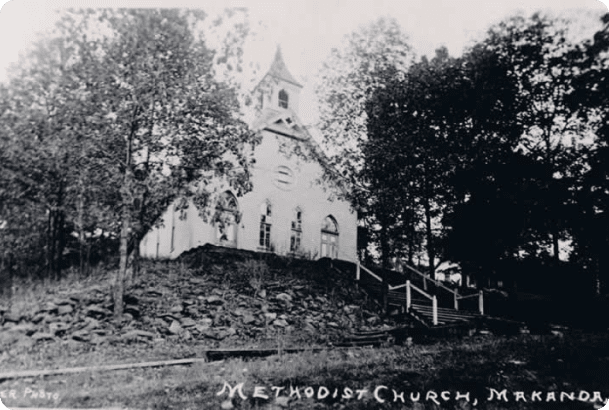 A church with stairs going up the side of it.