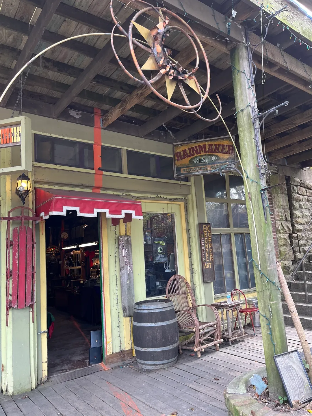 A store front with an old fashioned fan hanging from the ceiling.